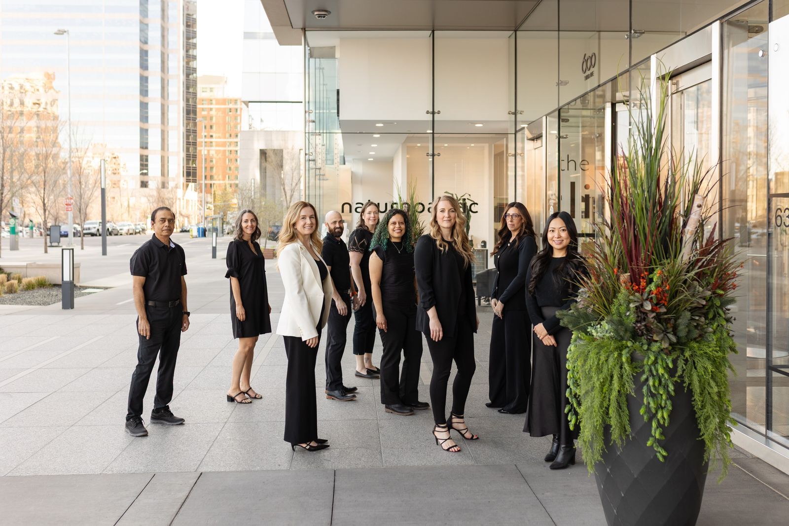 Dr. Jennifer Graas and the Eau Claire Park Dental team standing outside the downtown Calgary boutique dental clinic.